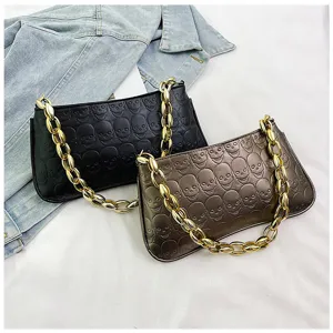 Fashion skull embossed underarm shoulder bag with chunky gold chain for women daily use.