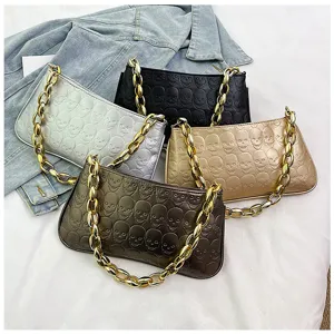 Stylish metallic skull embossed PU leather shoulder bag with chunky gold chain strap.