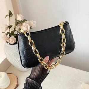 Black debossed skull underarm shoulder bag with chunky gold chain strap for women main view