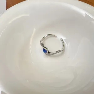 Bague coeur bleu en argent, vue de detail, bijou ouvert argente style retro ondule.
