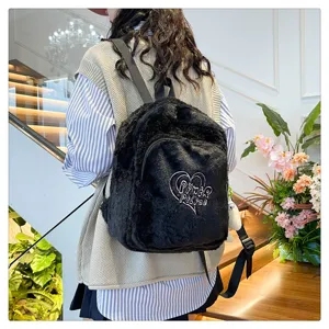 Stylish black plush backpack for women, casual fuzzy school bag with cute heart design.