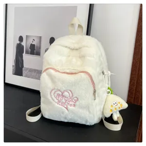 Fluffy white plush backpack for women, cute school bag with heart embroidery and soft texture.