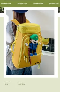 Large capacity yellow travel backpack with cute character pendant, durable and lightweight.