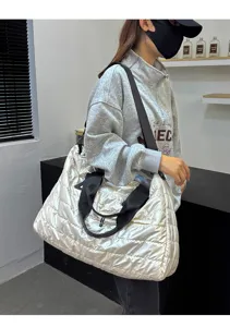 Silver quilted puffer tote bag detail, stylish lightweight travel luggage shoulder bag for daily.