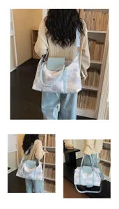 Detailed view of the stylish oil painting print travel shoulder bag with blue handles.