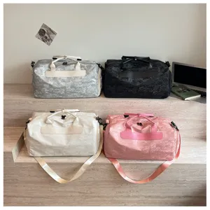 Gros plan de sacs de voyage élégants en quatre couleurs avec sangles robustes et texture chic.