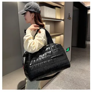 Black quilted puffer travel tote bag, lightweight large capacity duffel bag for fitness and sport.