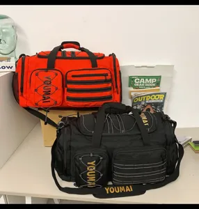 Multifunctional travel duffel bag with multiple pockets and straps for fitness and outdoor use.