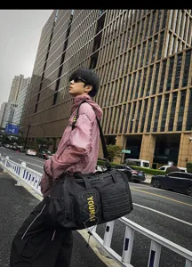 Detailed shot of stylish black travel duffel bag with yellow straps for gym and fitness.