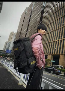 Urban outdoor scene showcasing a large multi-functional travel backpack in black style.