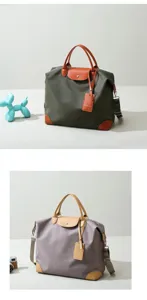 Large capacity nylon travel bag with leather handles and folding design for outdoor sports.
