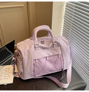 Detail view of purple travel duffel bag, large capacity gym bag with front mesh pocket.