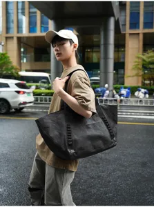 Black large capacity travel tote bag for commuting and outdoor activities with durable shoulder straps.