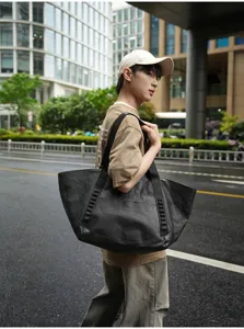 Large capacity black travel tote bag, perfect for outdoor commuting and short trips.