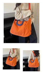 Travel bag detail view showing expandable large capacity design with orange fabric.