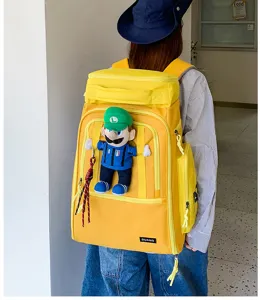 Large capacity yellow travel backpack with cartoon doll decor for outdoor sports and daily commute.