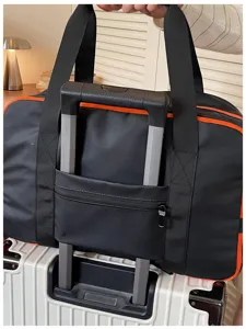 Detail view of black color-blocked travel duffel bag with trolley sleeve and sturdy carry handles.
