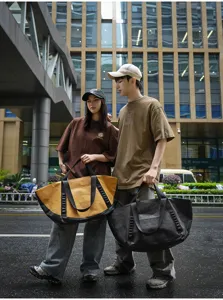 Outdoor travel duffel bag detail, large capacity canvas tote for commuting, camping, and short trips.