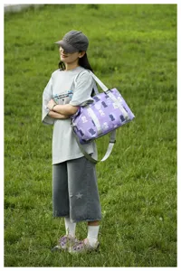 Cute bear print travel duffel bag detail showing shoulder strap and large capacity design.