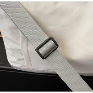 Travel bag shoulder strap detail, durable gray webbing and adjustable black plastic buckle.