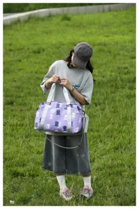 Cute bear print travel duffel bag detail, stylish canvas weekender shoulder luggage for women.