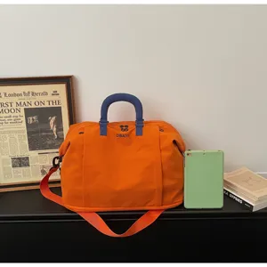 Large capacity travel duffel bag orange gym sports bag overnight portable luggage bag.