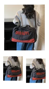 Black and red travel duffel bag with shoulder strap and letter print for short trips
