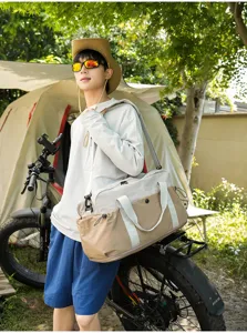 Outdoor travel bag detail showing durable color-blocked fabric and sturdy shoulder strap.