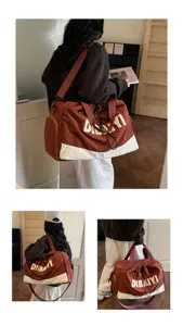 Detail view of the stylish brown travel duffel bag showing multiple carrying angles and features.