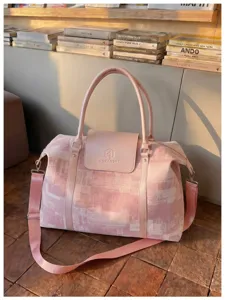 Pink oil painting style travel duffel bag detail, featuring durable handles and strap.