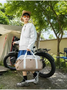Outdoor camping travel duffel bag detail showcasing color-blocked design and adjustable shoulder strap.