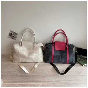 Versatile canvas travel duffel bag with shoulder strap, stylish casual weekend luggage bag.