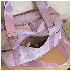 Close-up of the stylish star-patterned travel duffel bag detail showcasing fabric texture.
