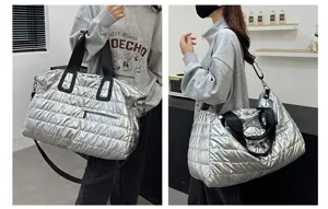 Silver puffer travel duffel bag with shoulder strap, large capacity gym sports bag.