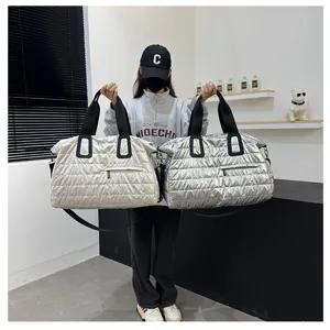 Large capacity quilted puffer travel duffel bag, stylish padded shoulder tote for gym.