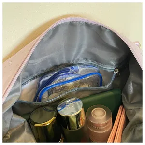 Travel bag detail interior view showing spacious storage capacity and convenient zipper pockets.