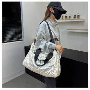 Detail view of stylish silver quilted tote bag, large capacity travel duffel for fitness and daily use.
