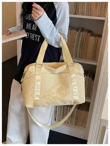 Stylish yellow star print travel duffel bag with shoulder strap for commute and gym.