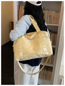Yellow starry travel shoulder bag detail view, stylish commuter tote bag for women daily use.