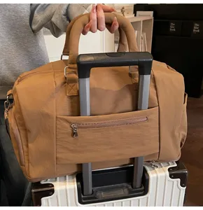Brown travel duffel bag with trolley sleeve, ideal for short trips, gym and weekend getaways.
