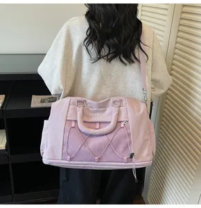 Light purple short trip travel bag with mesh pocket and shoulder strap detail view.