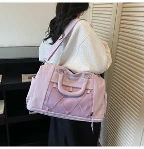 Detail view of the light purple travel duffel bag showing mesh pockets and durable straps.