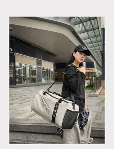 Outdoor scene detail of a stylish travel duffel bag with shoulder strap and spacious design.