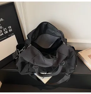 Travel duffel bag interior detail, featuring spacious storage compartment and zipper pockets.