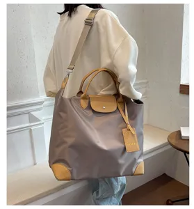 Large capacity nylon travel bag with leather flap, lightweight waterproof luggage bag.