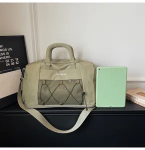 Detail shot of the light green travel duffel bag featuring wet-dry mesh pocket design.