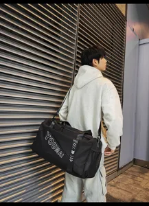 Detailed view of the large capacity black sports gym duffel bag with shoulder strap.