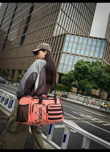 Detailed view of the pink fashion duffel bag featuring multiple compartments and durable straps.