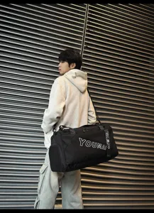 Detailed view of black travel duffel bag, large capacity gym bag for men and sports commute.