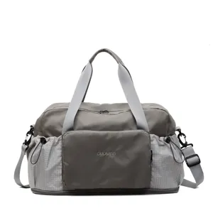 Grey folding travel duffel bag for women, large capacity fitness gym bag with compartments.